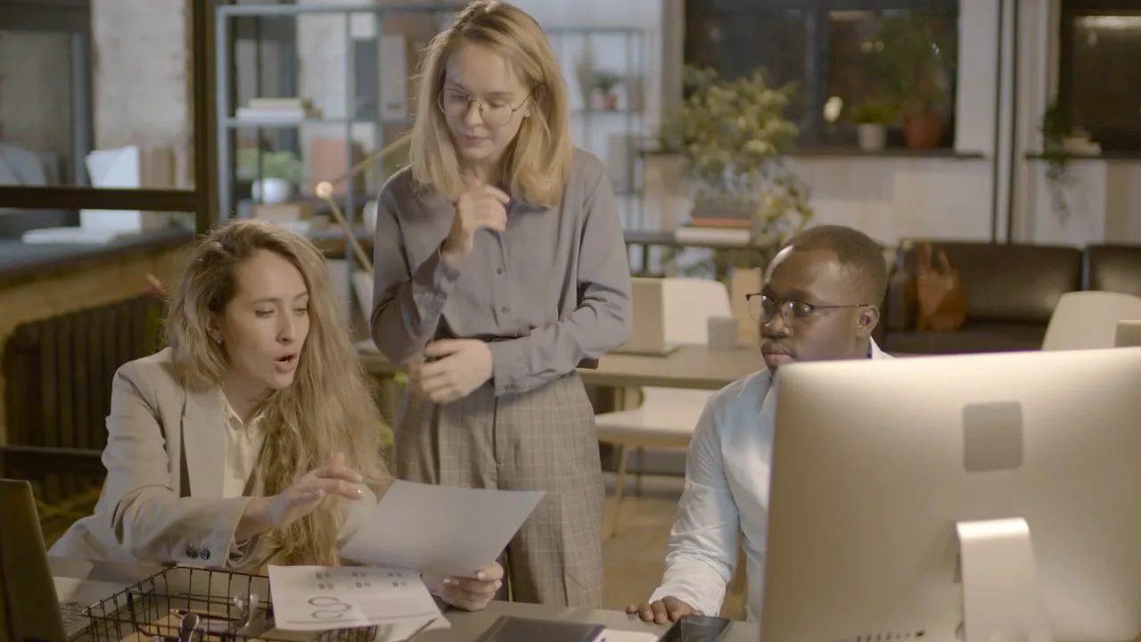 Colleagues checking a document against a screen