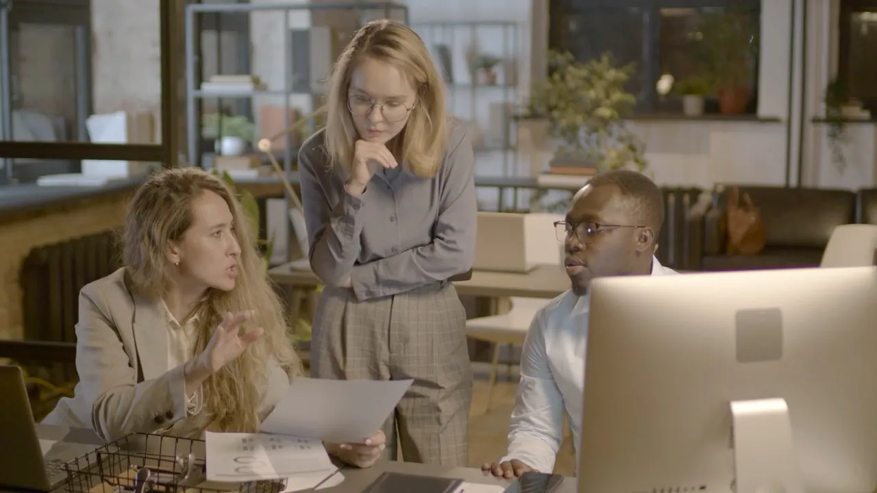 An adviser talking a colleague through a document