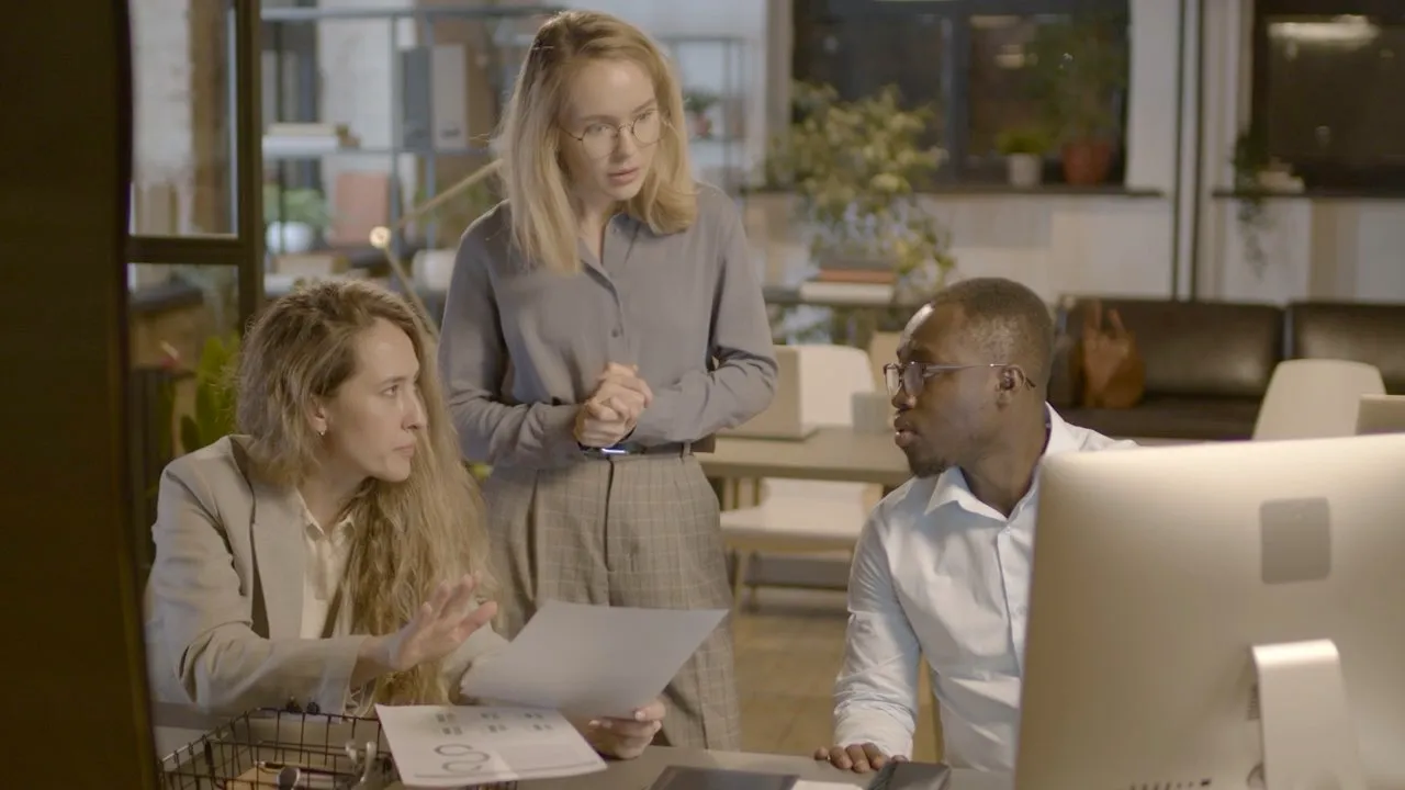 An adviser drafting while a colleague reads
