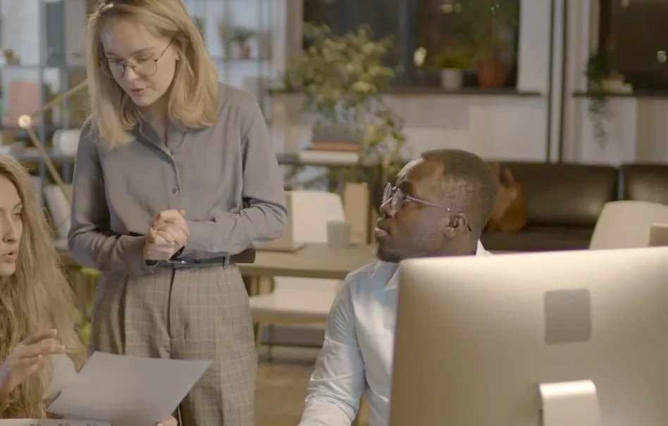 An adviser and a colleague working at a screen in a New Zealand practice.